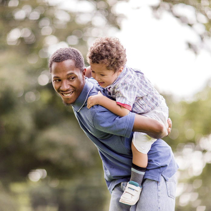 Playful African American father and son.