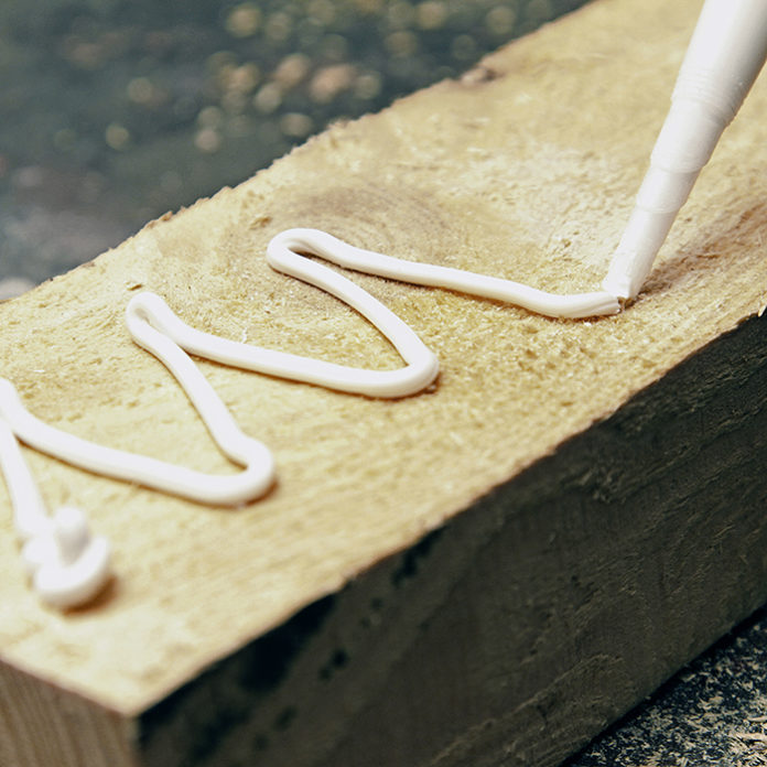 putting glue on a piece of wood