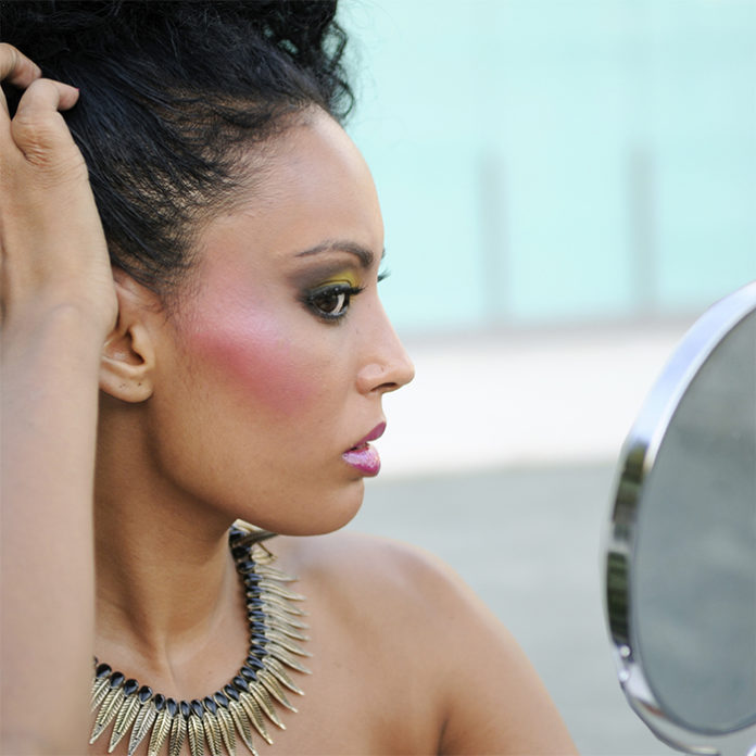 Beautiful black girl with mirror