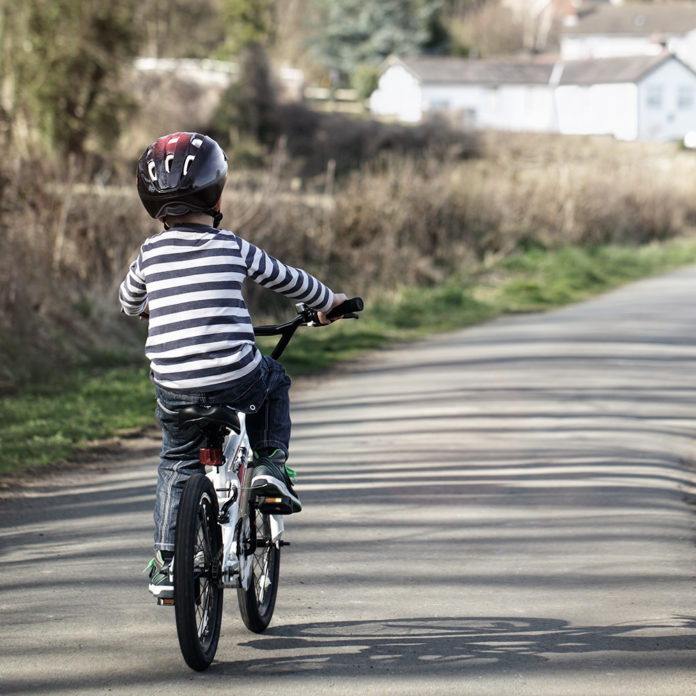 Boy learning to ride his bike bicycle