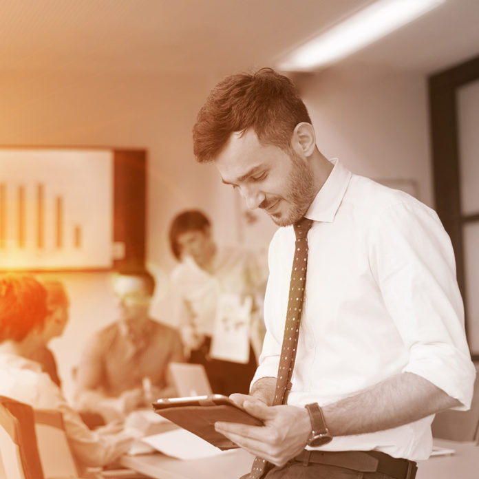 young business man with tablet at office meeting room